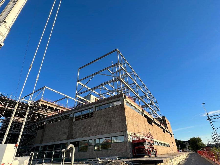 Steel frame of the extension above the existing building, with crane